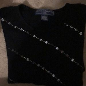 Black sweater adorned with beading and sequins.